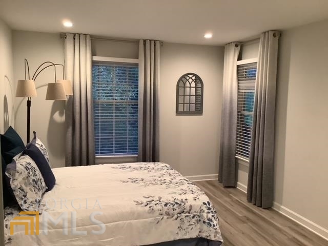 3097 Colonial Way, Unit M Chamblee, GA 30341 - Photo 9 of 11 a bedroom with a bed and a window