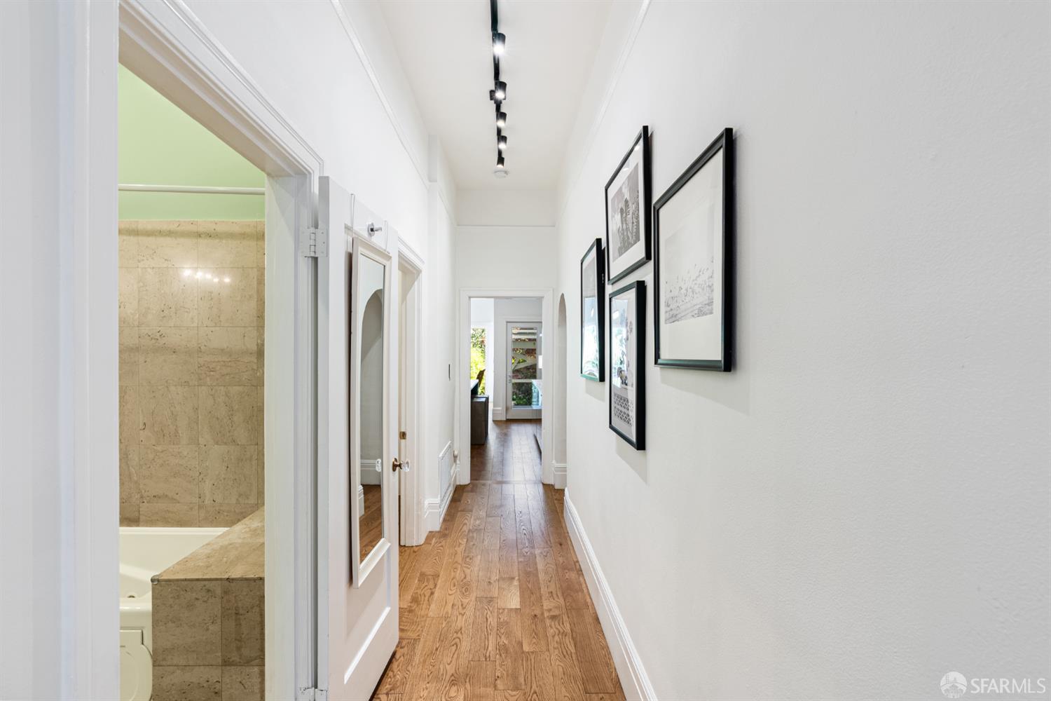 223 Sanchez Street San Francisco, CA 94114 - Photo 14 of 27 a view of a hallway with wooden floor and staircase