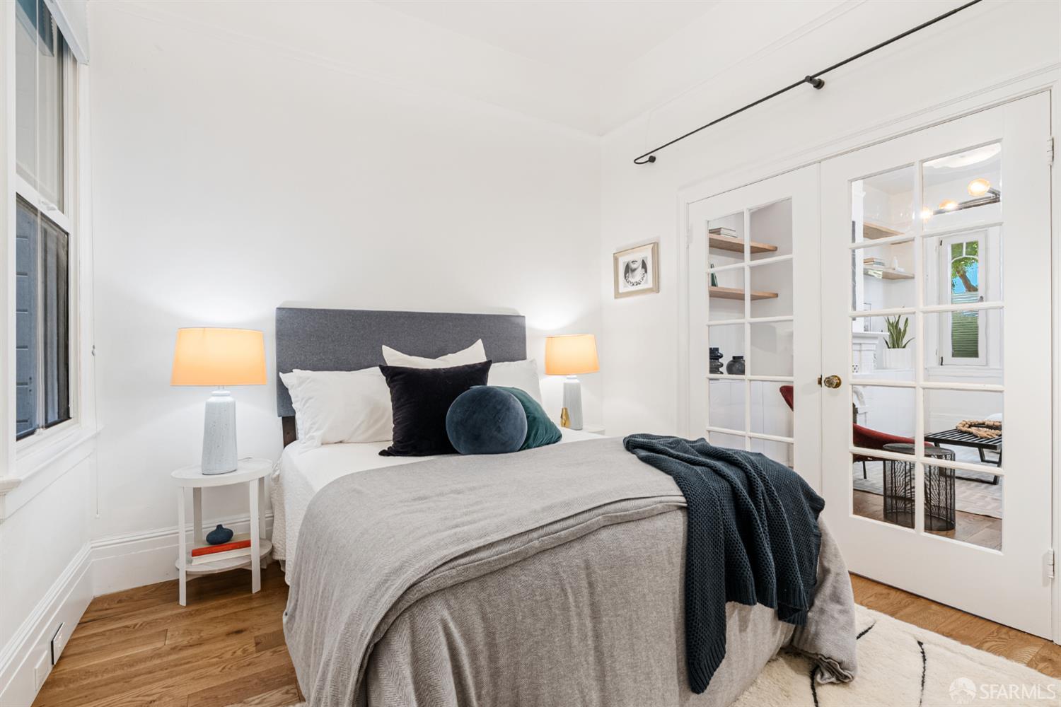 223 Sanchez Street San Francisco, CA 94114 - Photo 15 of 27 a bedroom with a bed and wooden floor