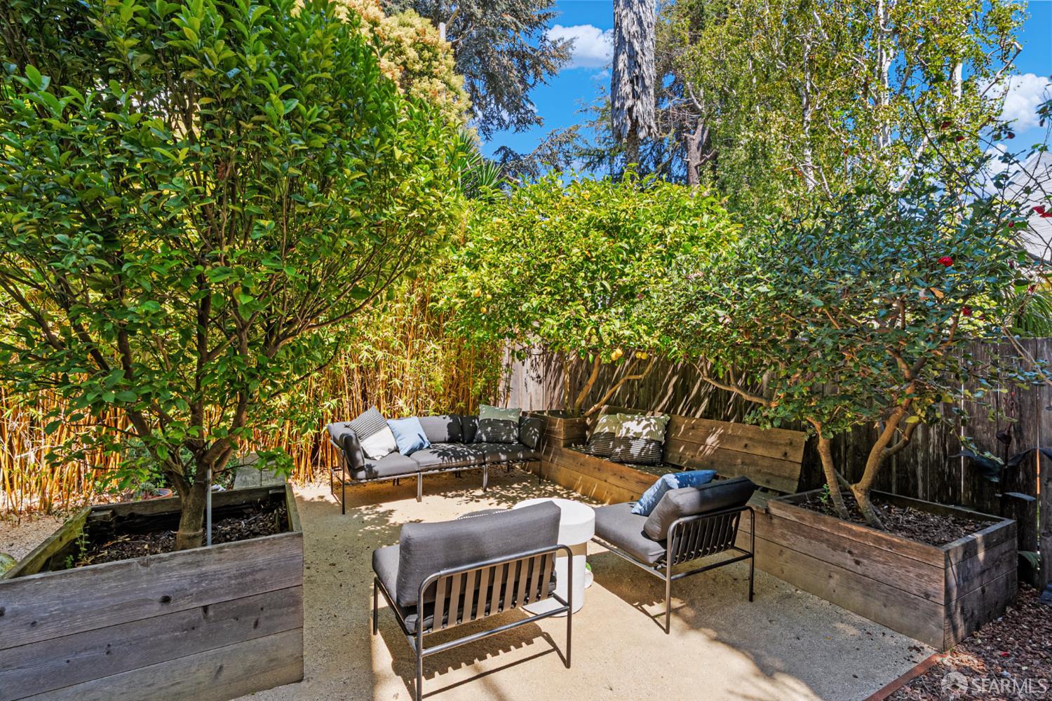 223 Sanchez Street San Francisco, CA 94114 - Photo 23 of 27 a view of a patio with couches and table and chairs with wooden floor and fence