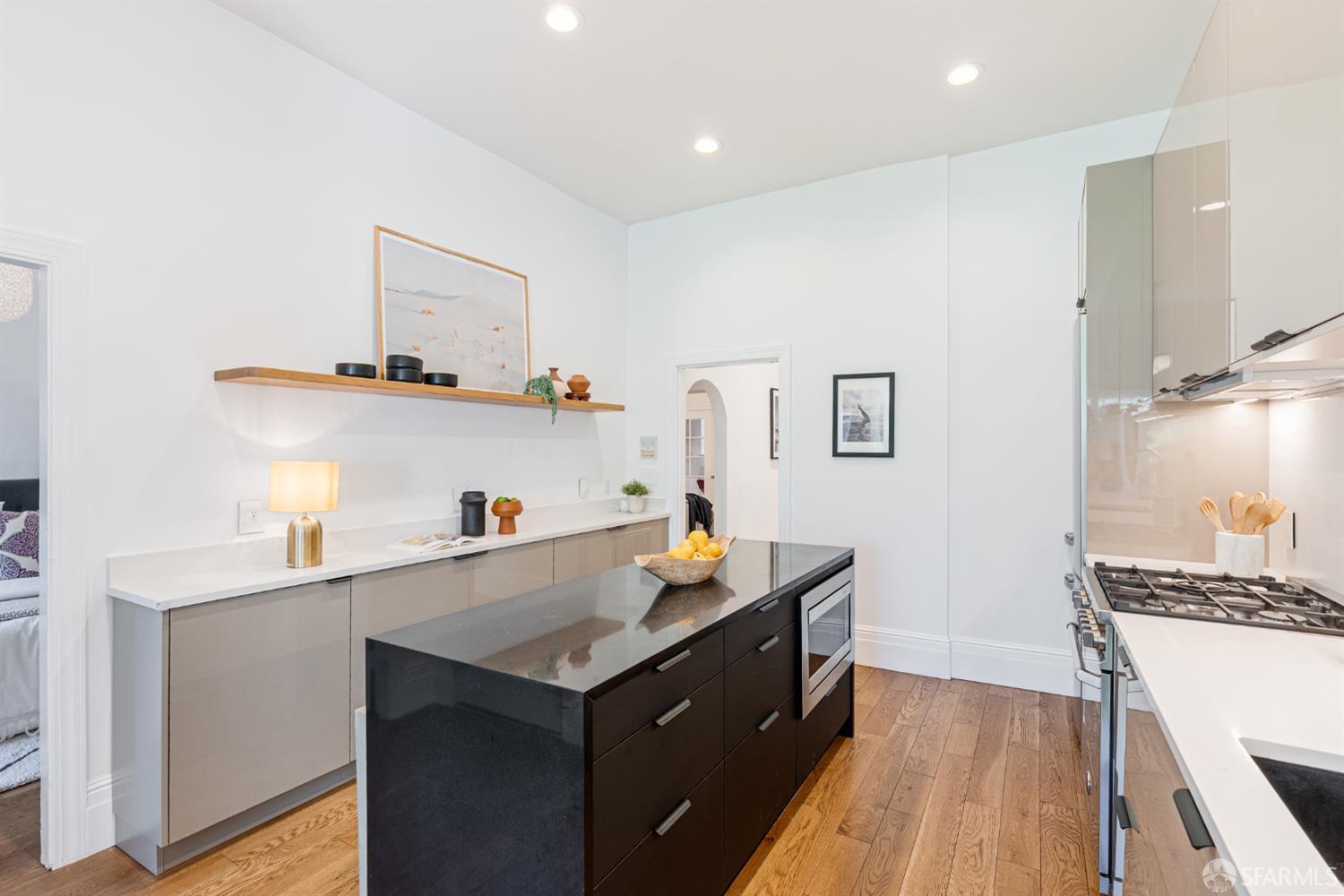 223 Sanchez Street San Francisco, CA 94114 - Photo 3 of 27 a kitchen with a sink a stove and wooden floor