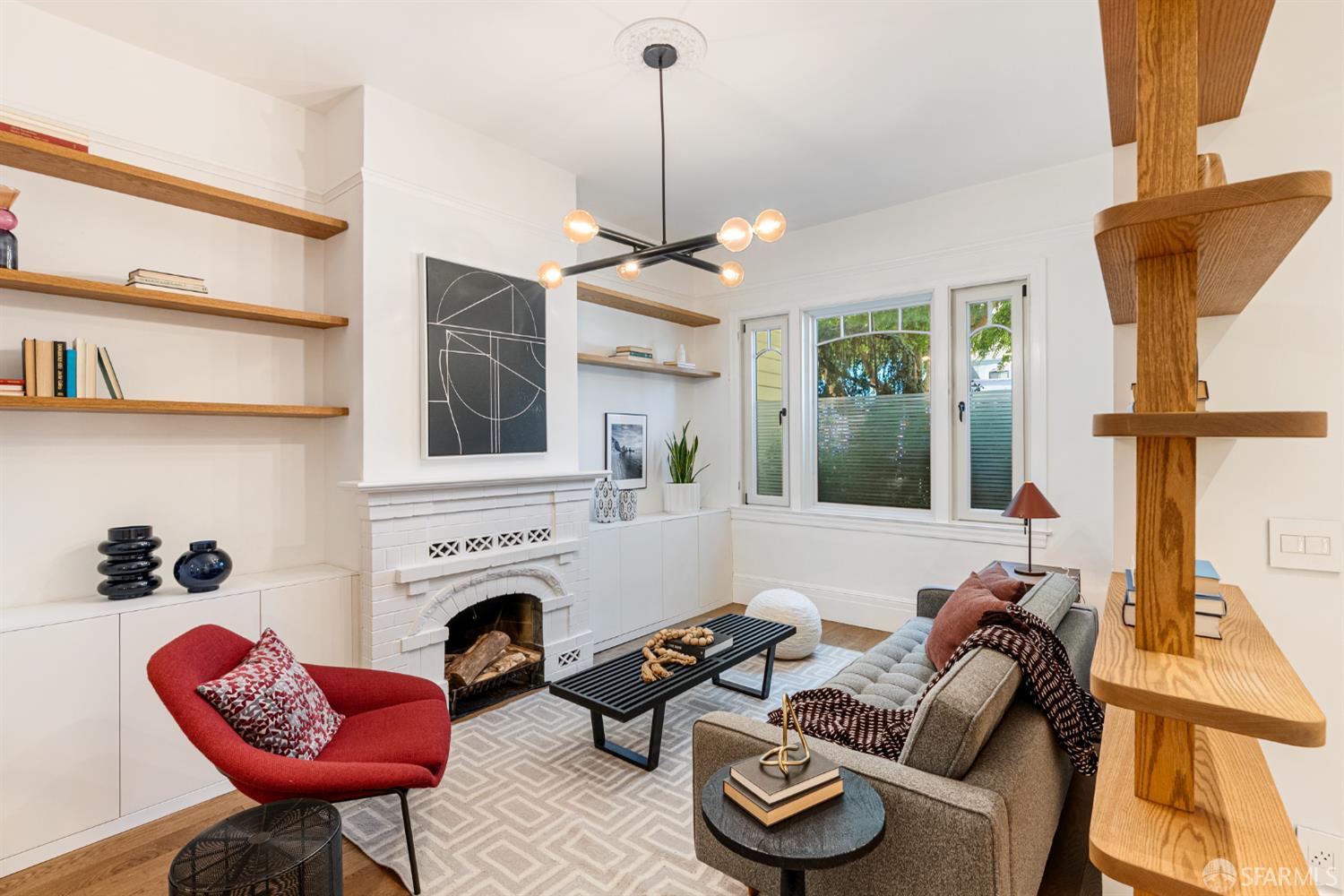 223 Sanchez Street San Francisco, CA 94114 - Photo 8 of 27 a living room with furniture a fireplace and a chandelier