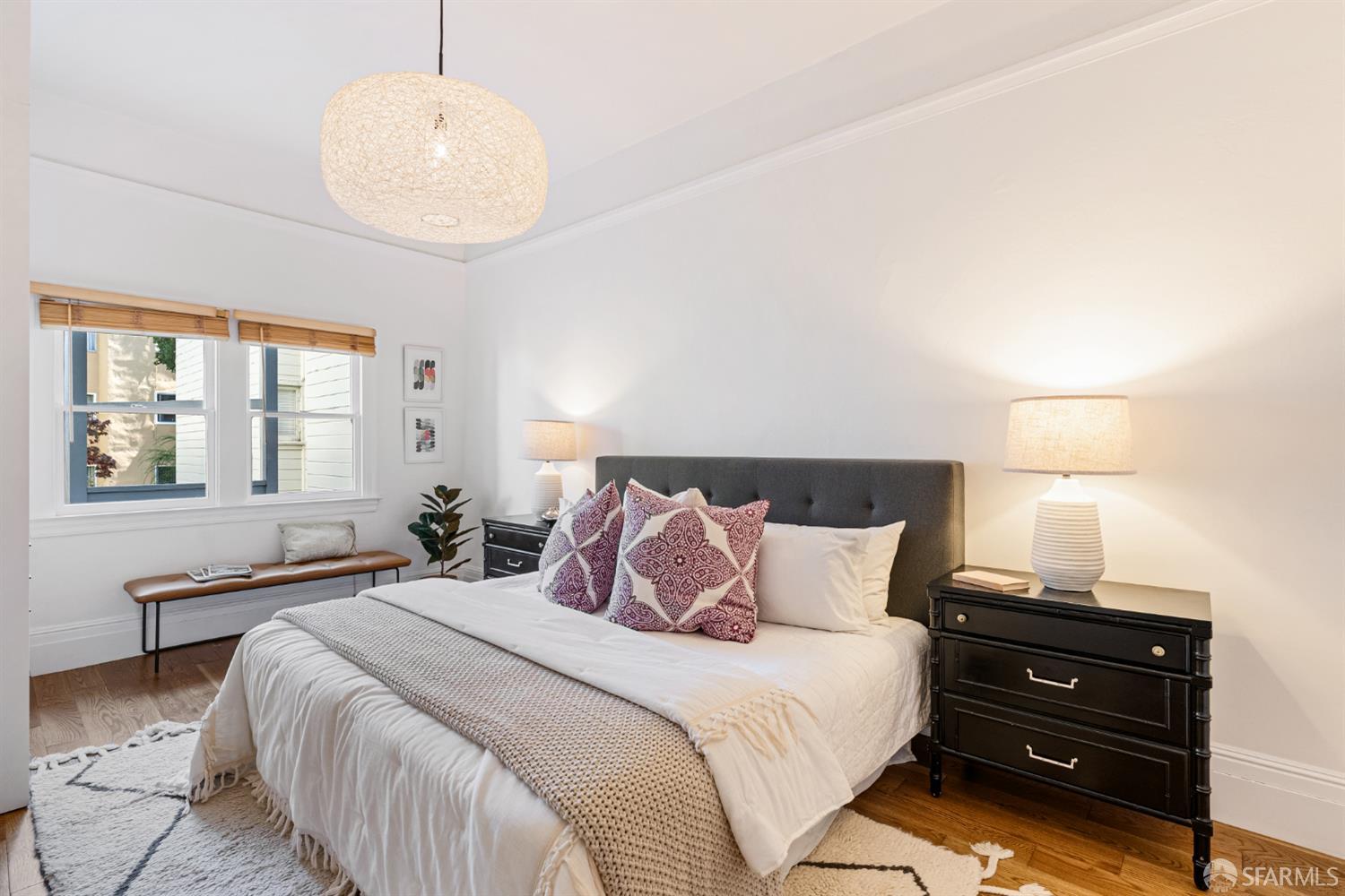 223 Sanchez Street San Francisco, CA 94114 - Photo 9 of 27 a bedroom with a bed and wooden floor