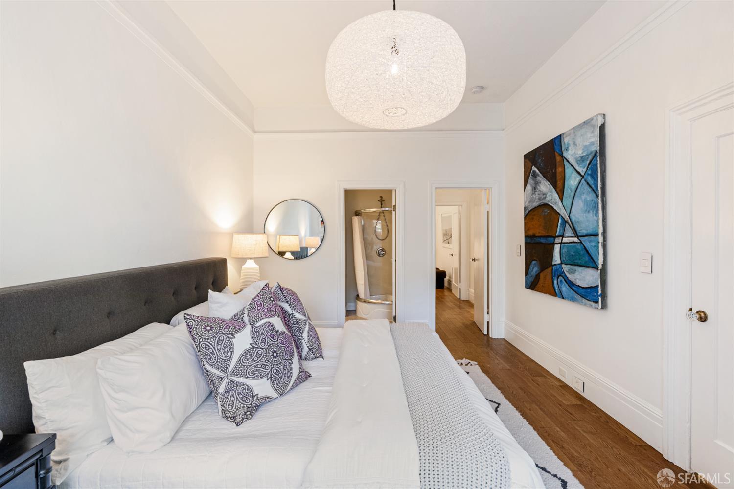 223 Sanchez Street San Francisco, CA 94114 - Photo 10 of 27 a bedroom with a large bed and a chandelier