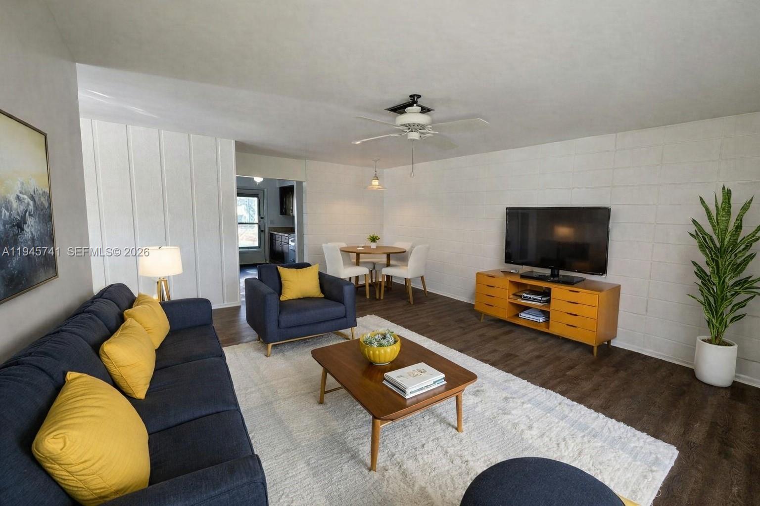 a living room with furniture and a flat screen tv