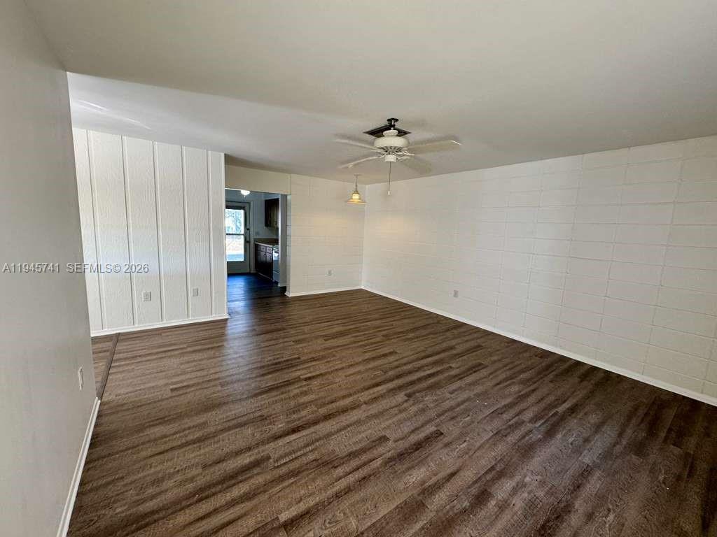 5100 Rilma Avenue Sarasota, FL 34234 - Photo 2 of 18 wooden floor in an empty room with a window