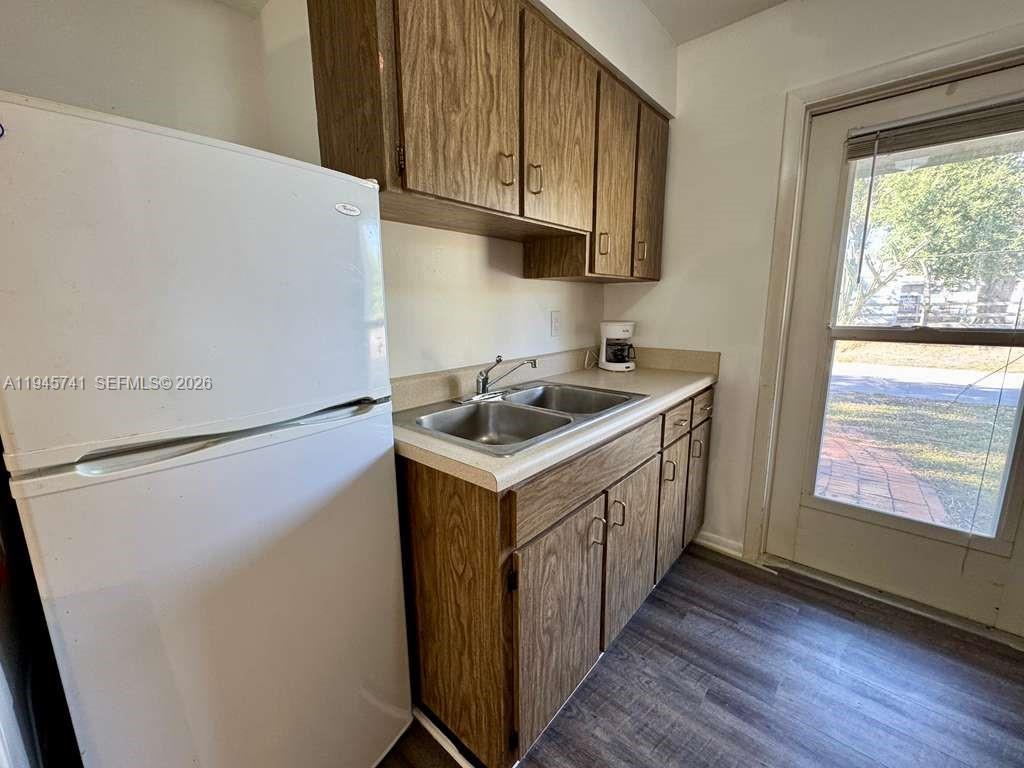 5100 Rilma Avenue Sarasota, FL 34234 - Photo 3 of 18 a utility room with wooden floor washer and dryer