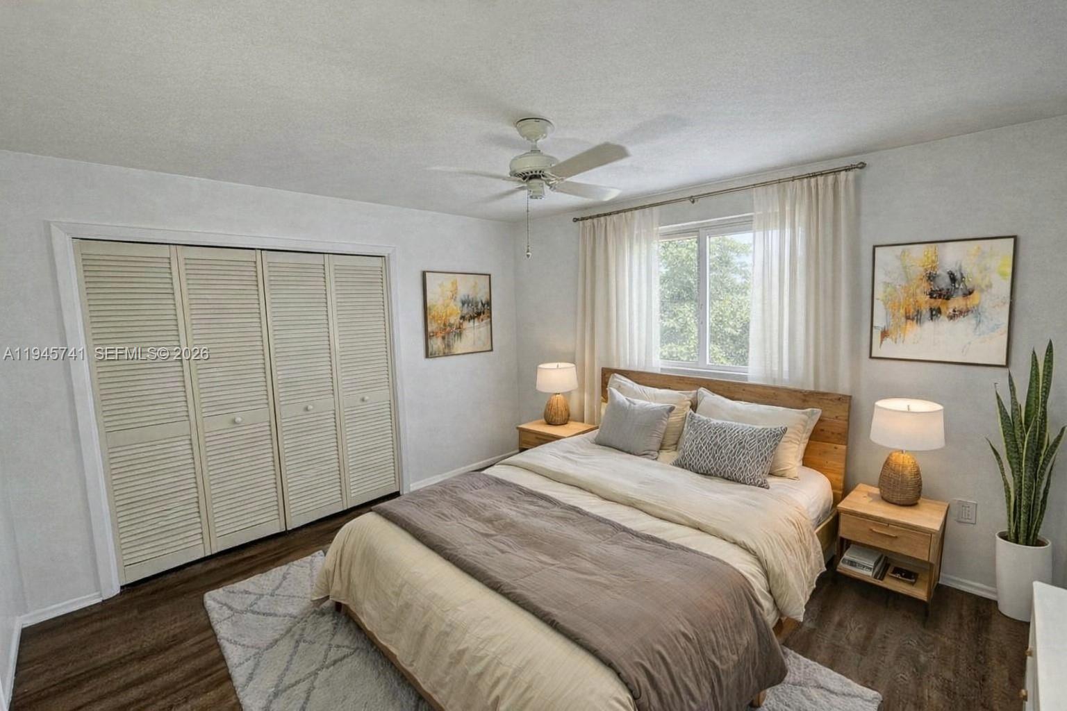 5100 Rilma Avenue Sarasota, FL 34234 - Photo 4 of 18 a bedroom with a large bed and a chandelier