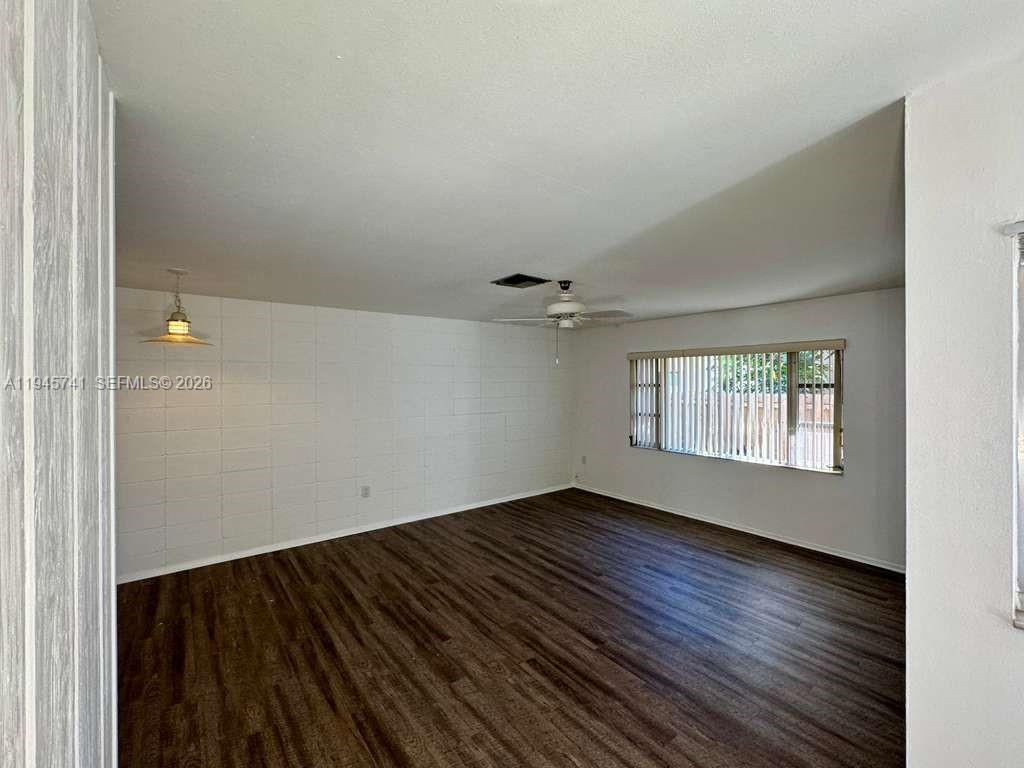 5100 Rilma Avenue Sarasota, FL 34234 - Photo 10 of 18 an empty room with wooden floor and windows