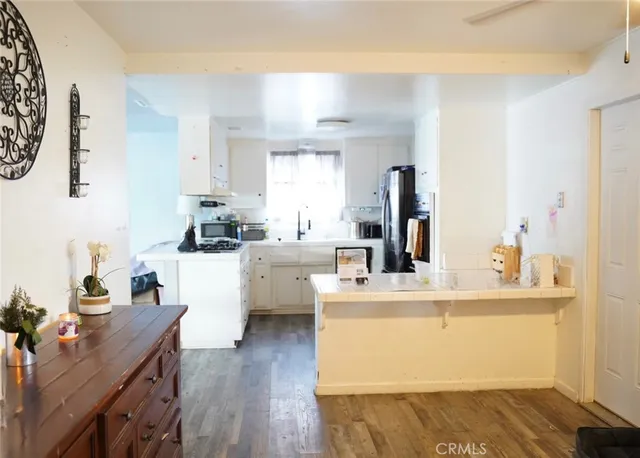 a kitchen with a sink appliances and cabinets