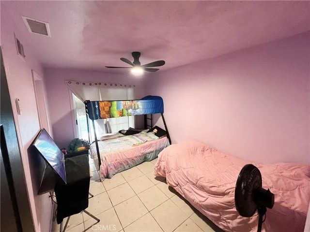 a bedroom with a bed and lamp