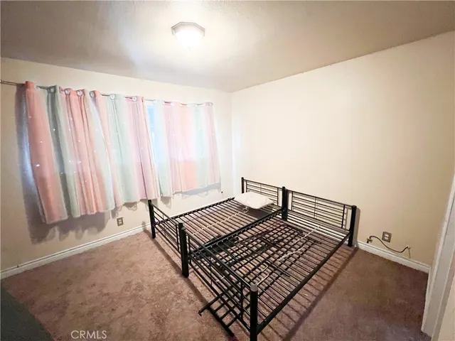 a view of room with stairs and a rug