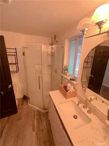 a bathroom with a tub sink and mirror