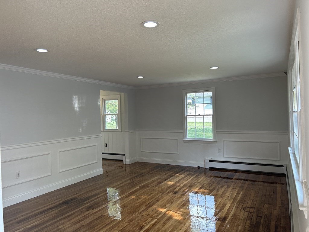 73 Lancaster Road Clinton, MA 01510 - Photo 13 of 34 a view of empty room with wooden floor and fan