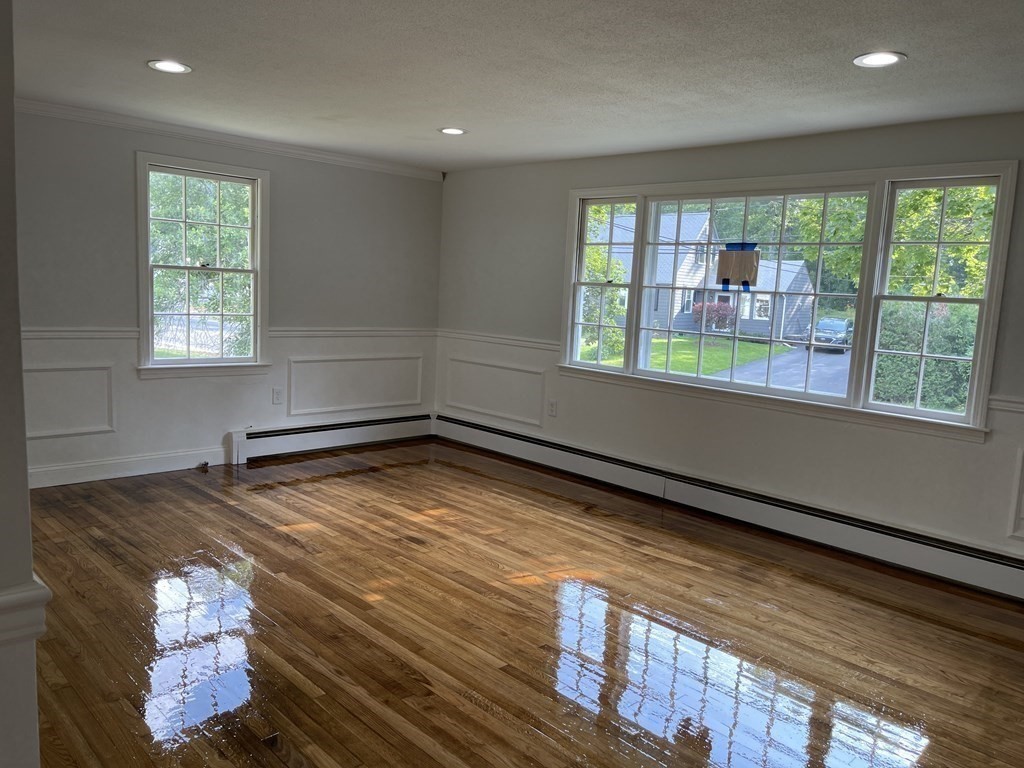73 Lancaster Road Clinton, MA 01510 - Photo 7 of 34 a view of an empty room with wooden floor and a window