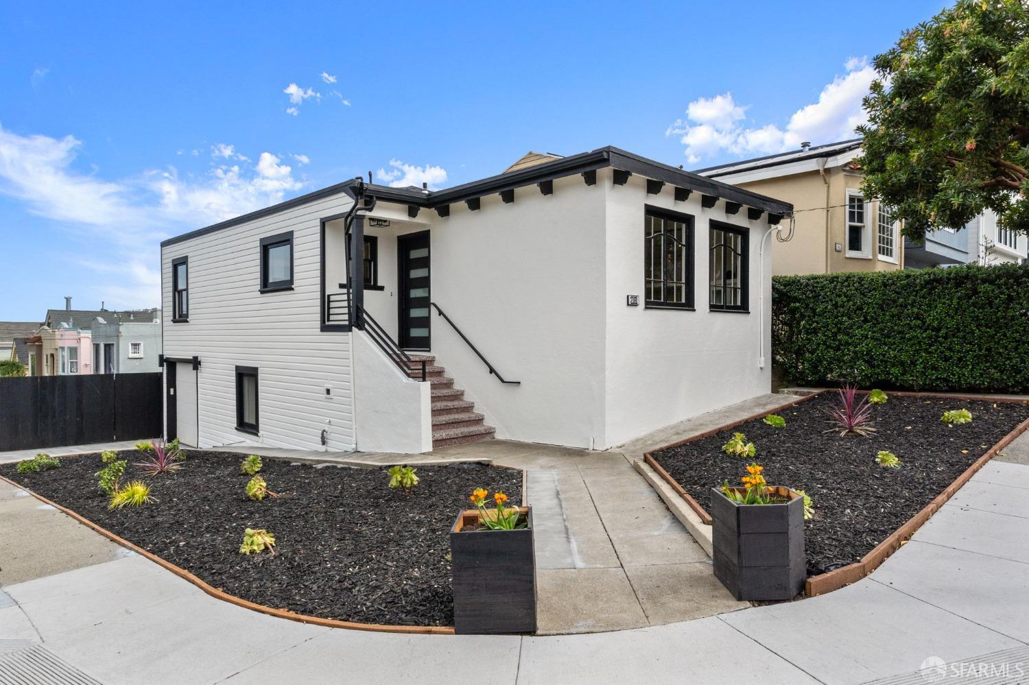 a view of a white house with large windows