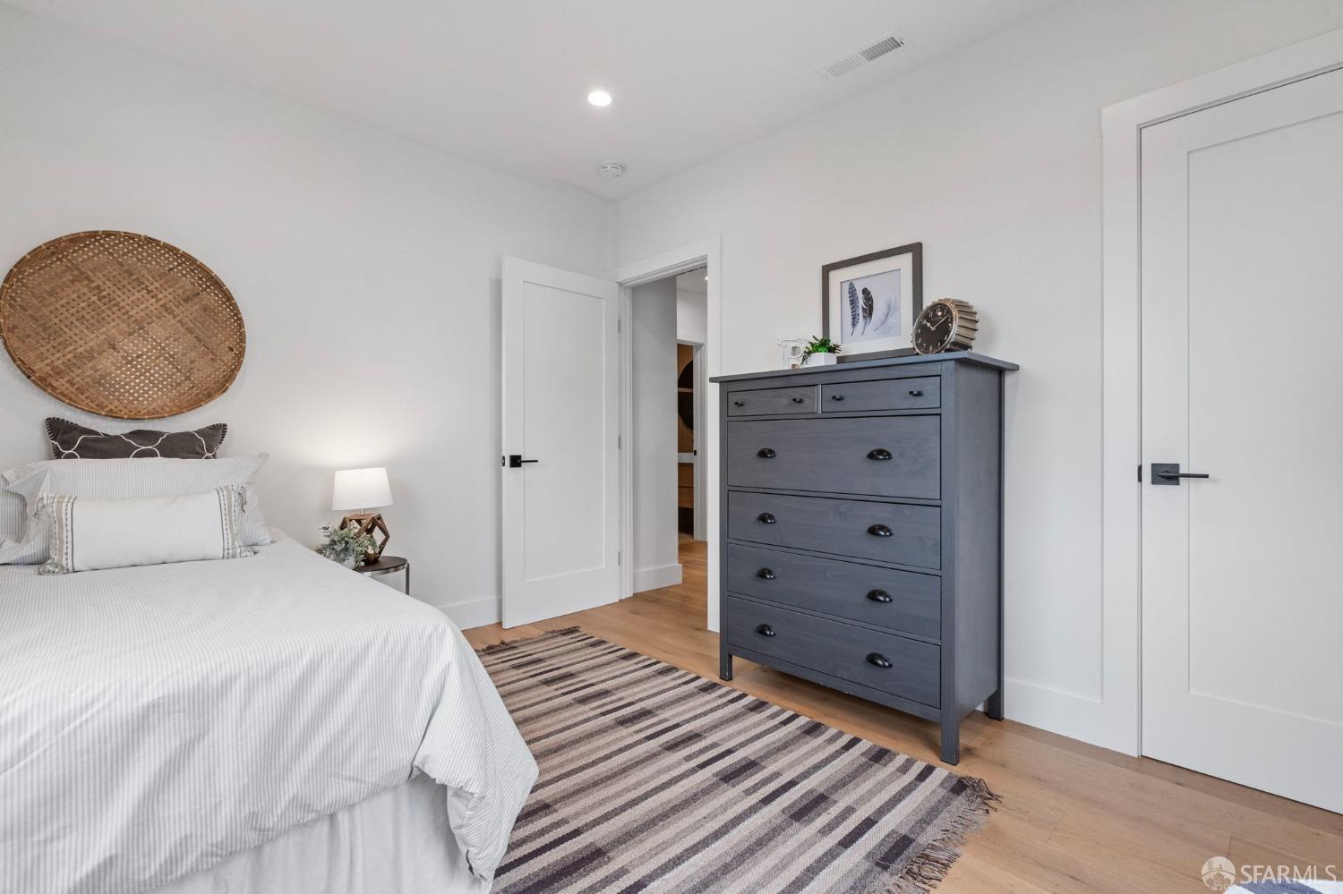 348 Edna Street San Francisco, CA 94112 - Photo 19 of 45 a bedroom with a bed and a potted plant