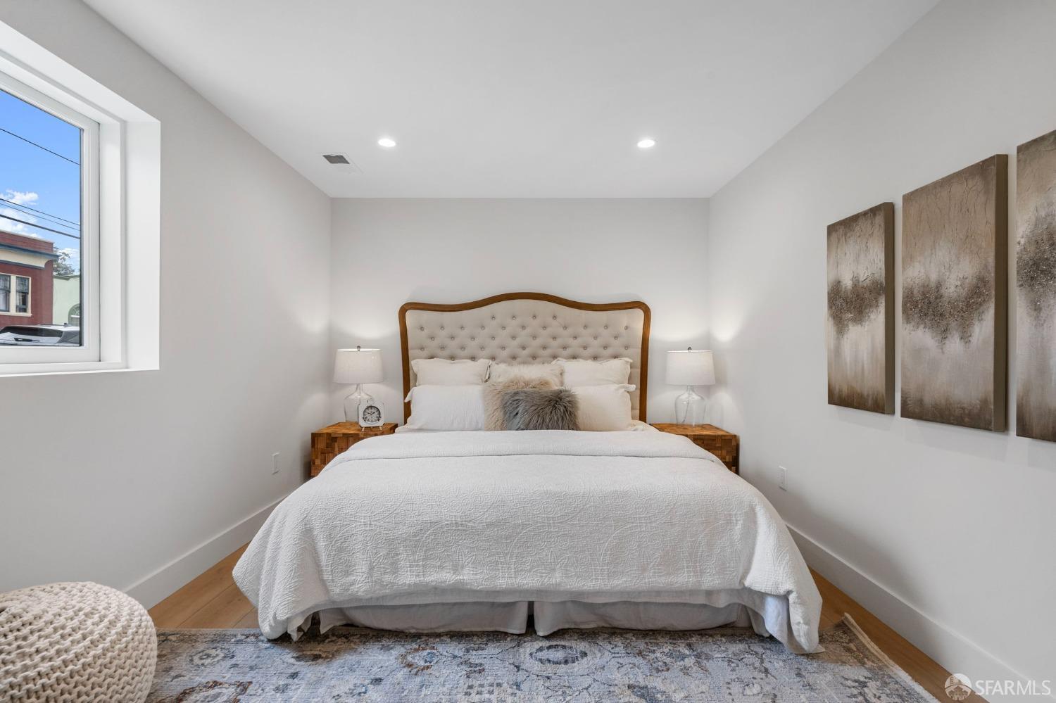 348 Edna Street San Francisco, CA 94112 - Photo 25 of 45 a large bed sitting in a bedroom next to a window