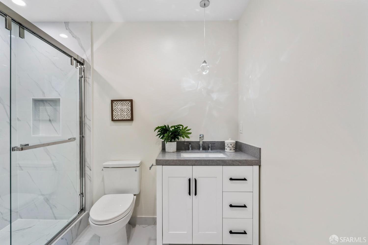 348 Edna Street San Francisco, CA 94112 - Photo 27 of 45 a bathroom with a granite countertop sink toilet and shower