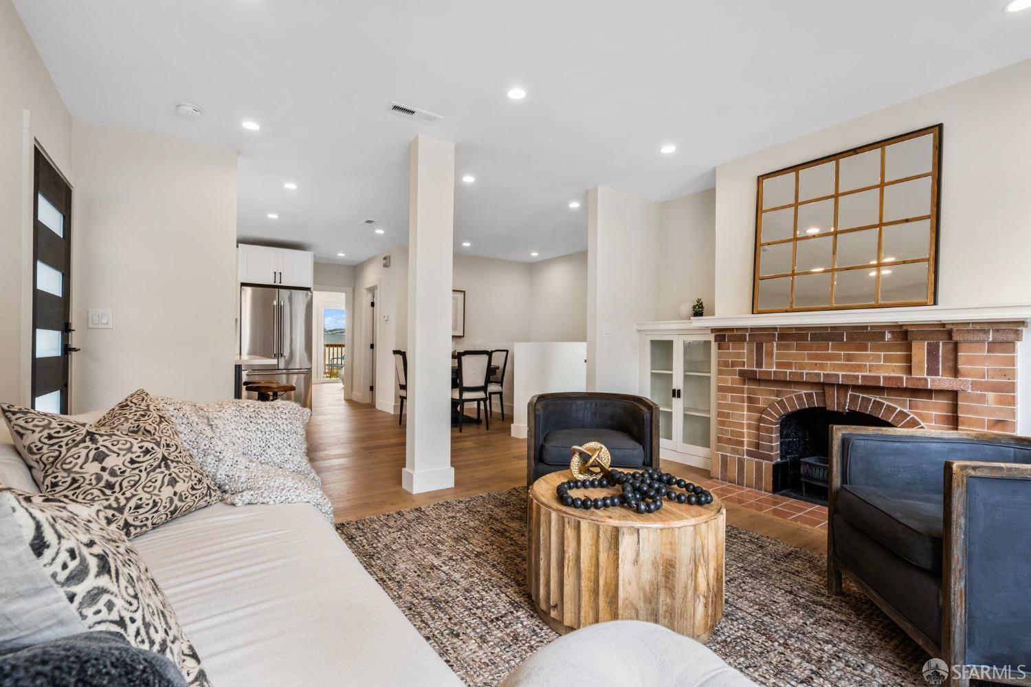 348 Edna Street San Francisco, CA 94112 - Photo 6 of 45 a living room with furniture a fireplace and a flat screen tv