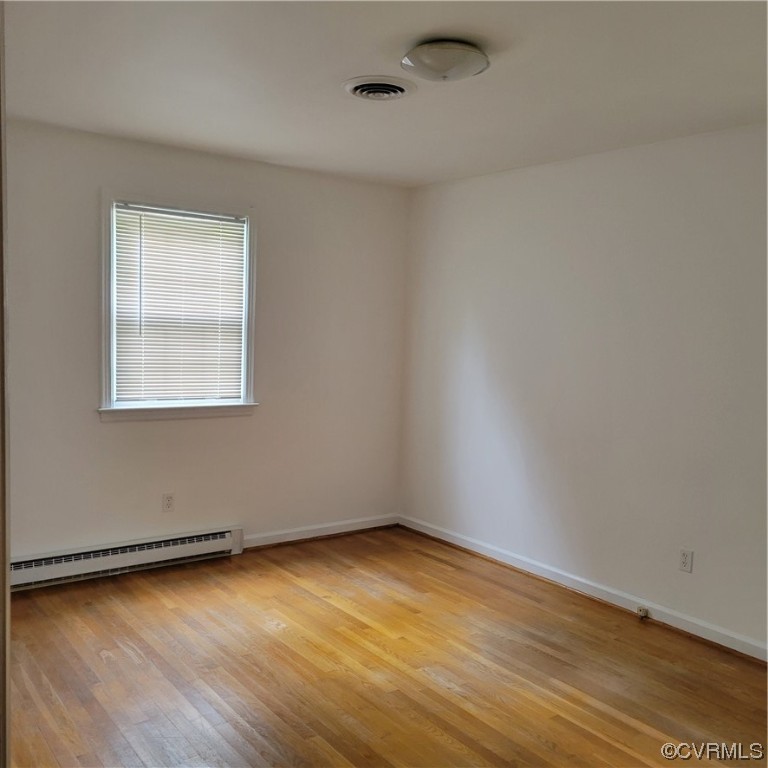 12500 Easy Street Chester, VA 23831 - Photo 3 of 5 an empty room with wooden floor and windows
