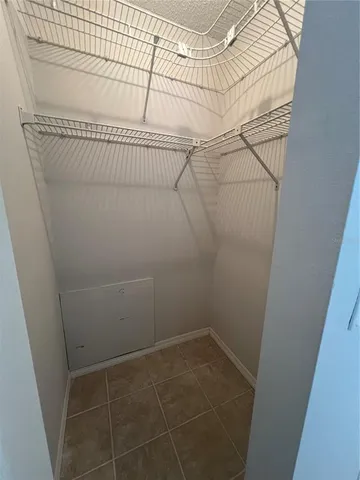 a view of a backyard with a large tree and wooden fence