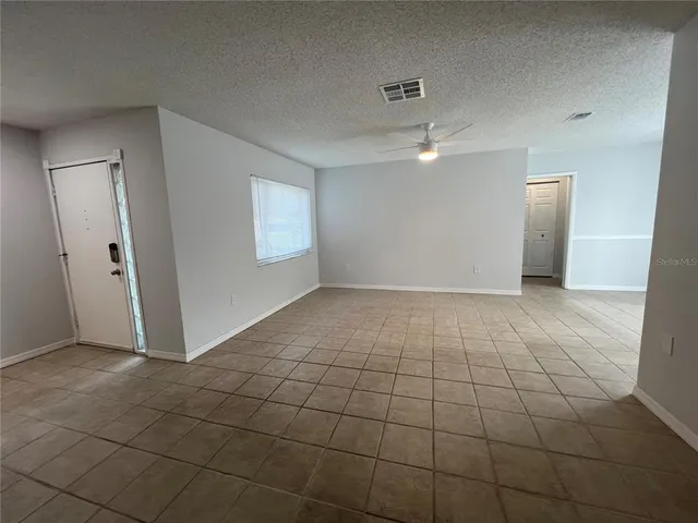 an empty room with white walls and tiles