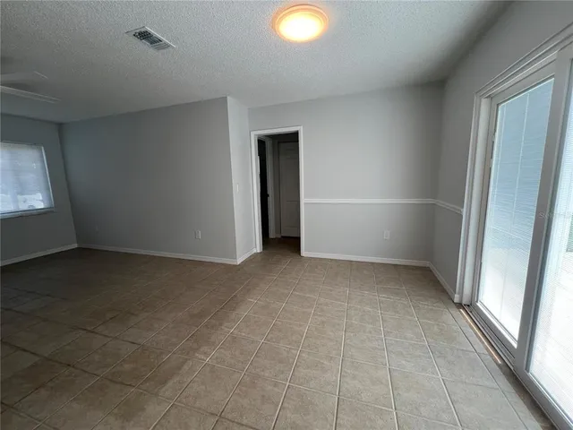 an empty room with a empty space and windows