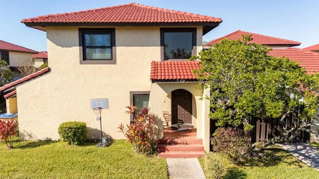 a front view of a house with garden