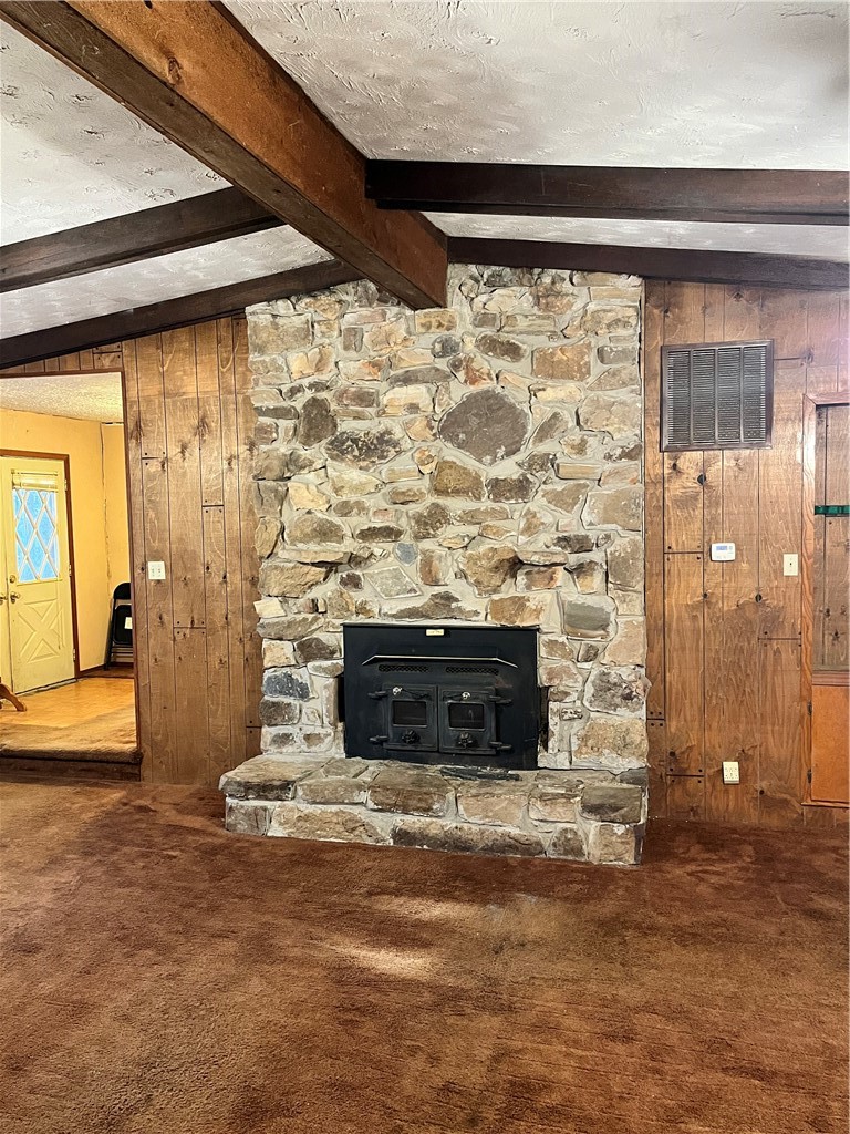 840 Miller Road Ola, AR 72853 - Photo 10 of 23 Detailed view of wood walls, beamed ceiling, carpet flooring, and a textured ceiling