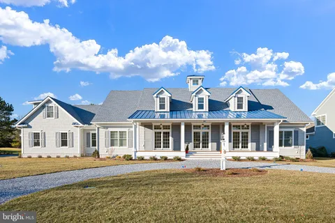 a front view of a house with a big yard