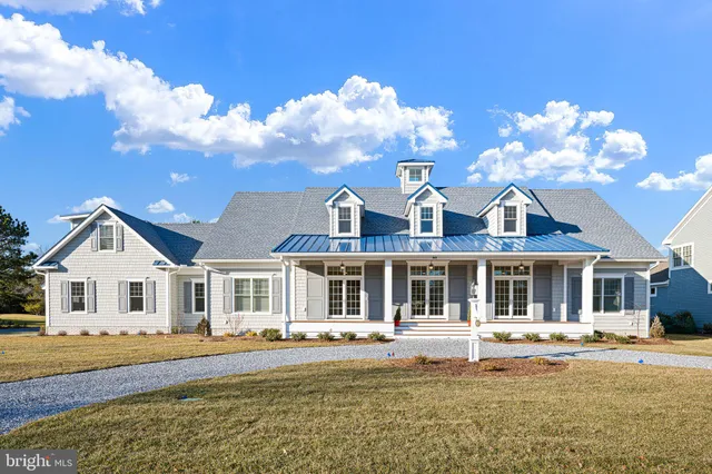 a front view of a house with a big yard
