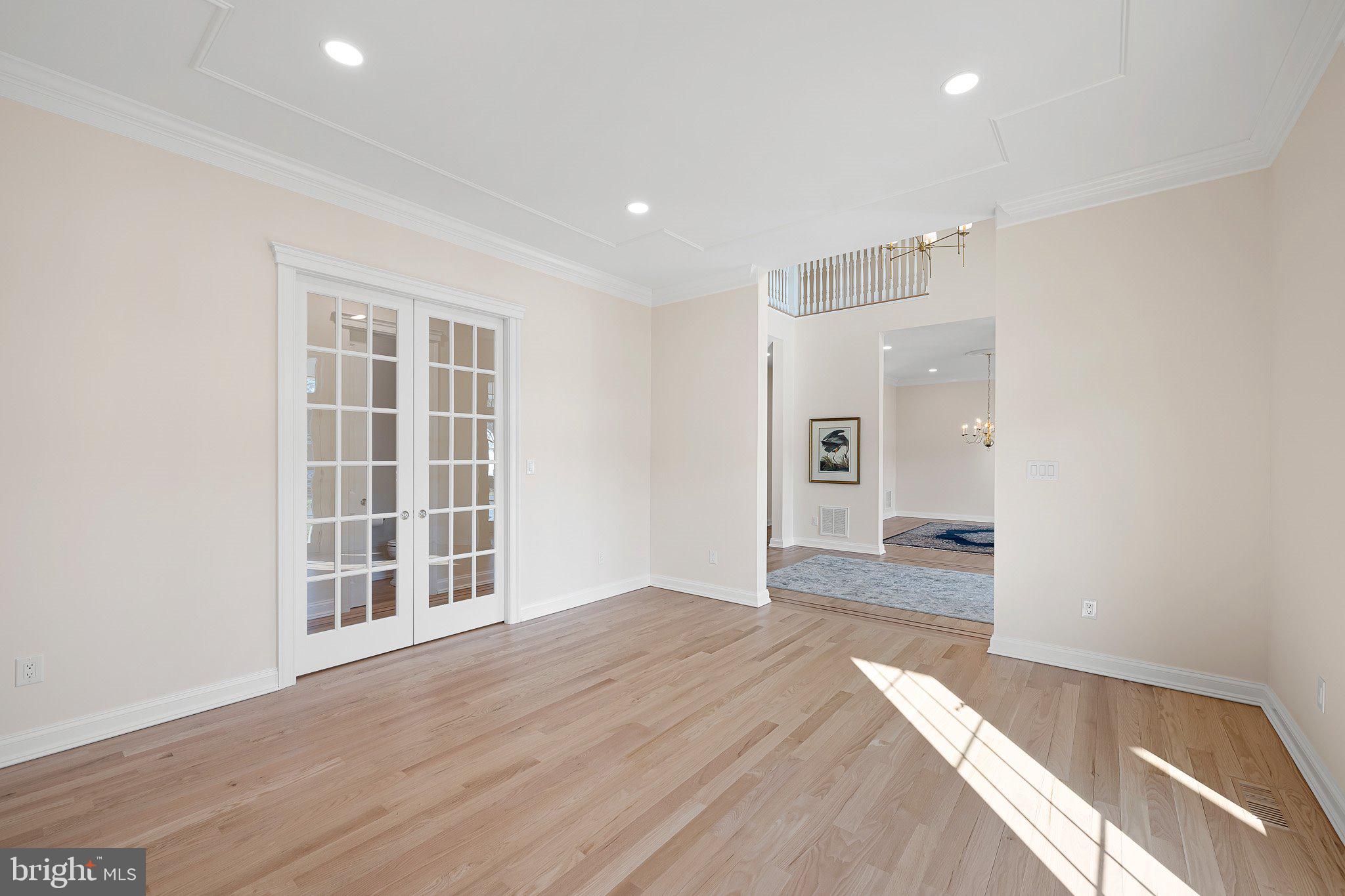 403 Canal Way East Bethany Beach, DE 19930 - Photo 11 of 51 a view of an empty room with wooden floor and a window