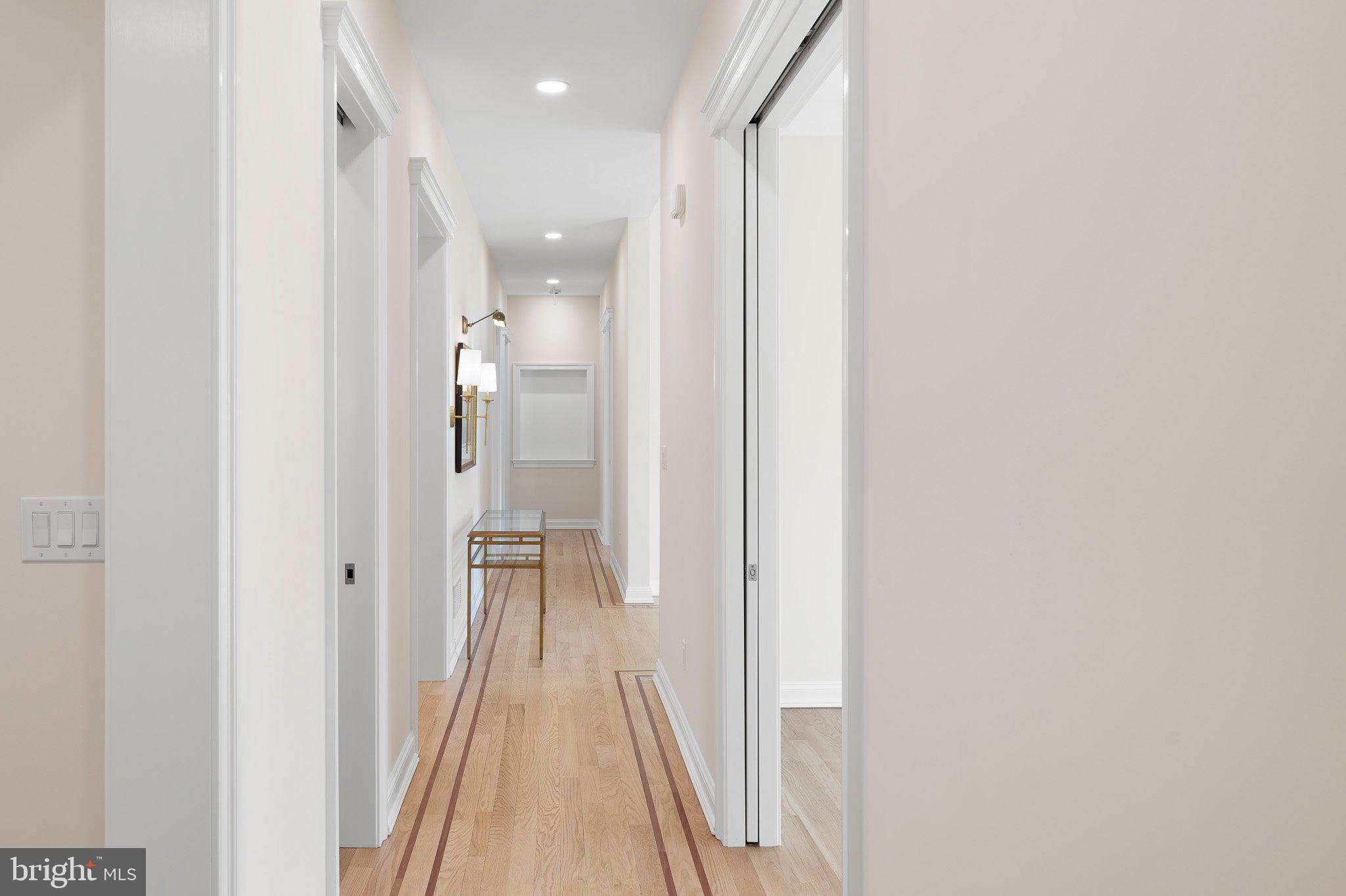 403 Canal Way East Bethany Beach, DE 19930 - Photo 14 of 51 a view of a hallway with wooden floor and a bathroom