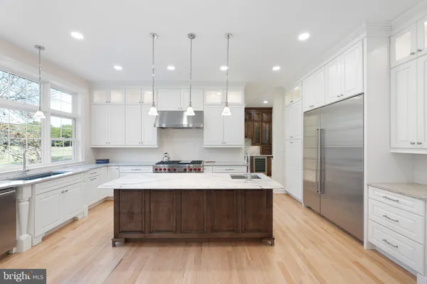 a kitchen with a sink stove and wooden cabinets