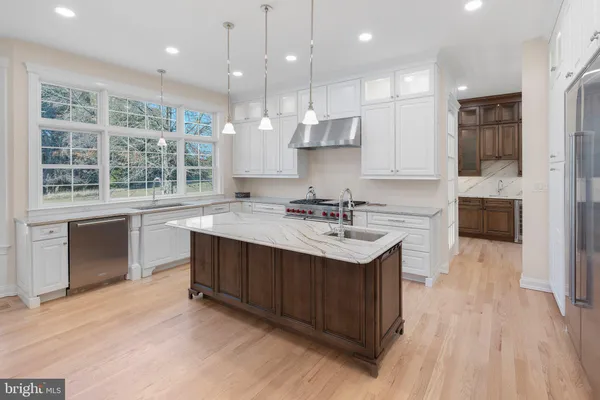 a kitchen with stainless steel appliances granite countertop a stove and a sink
