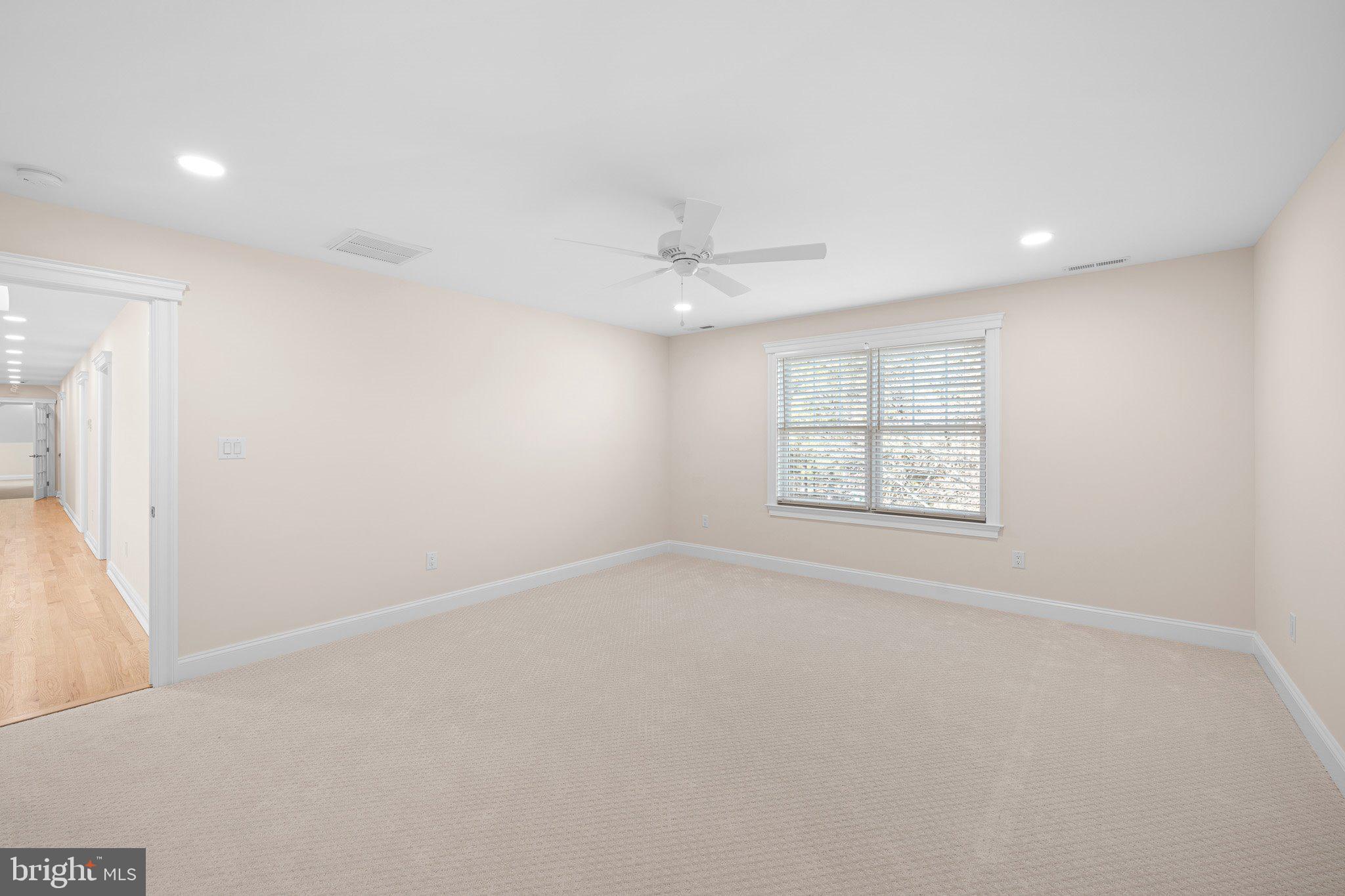 403 Canal Way East Bethany Beach, DE 19930 - Photo 41 of 51 an empty room with a window and a ceiling fan