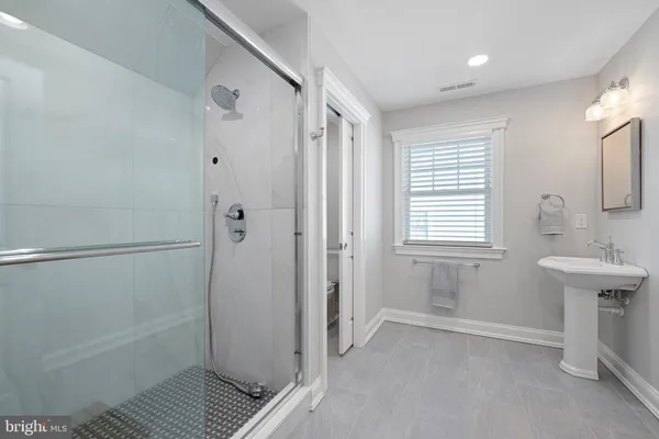 a bathroom with a sink a toilet and mirror