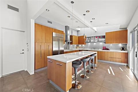 a view of kitchen with stainless steel appliances granite countertop a stove and a refrigerator