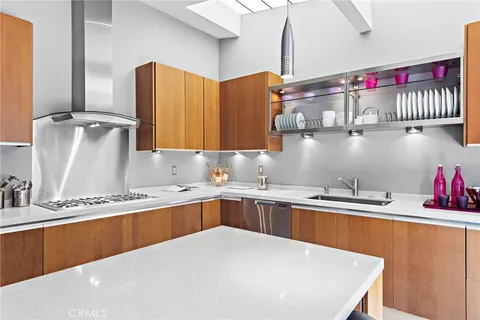 a kitchen with stainless steel appliances a sink and a refrigerator