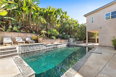 a view of a backyard with sitting area