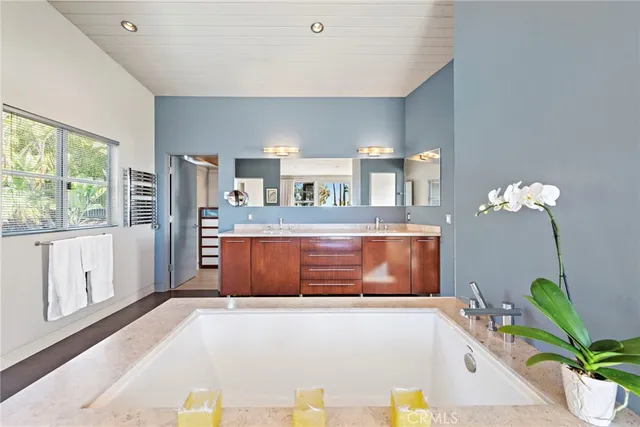 a living room with a large window and chandelier