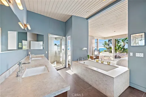 a large white room with a large window and furniture