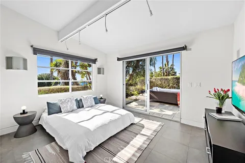 a bedroom with furniture and a window