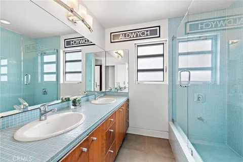 a spacious bathroom with a sink double vanity and a mirror