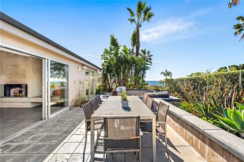 a view of a patio with table and chairs and potted plants