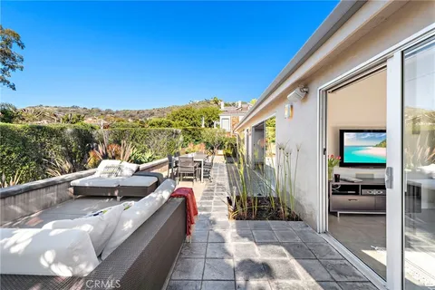 a view of roof deck with couches and sky view