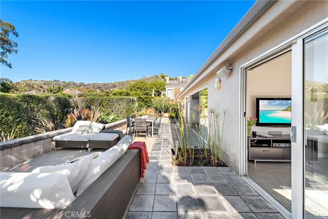 a view of roof deck with couches and sky view