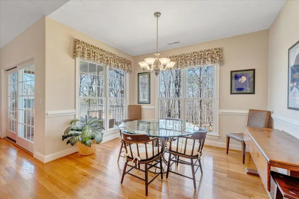 a view of a dining room with furniture window and wooden floor