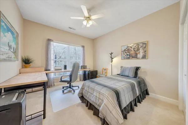 a bedroom with a bed and a desk
